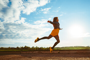 girl in skirt jumps high