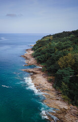 Aerial view over rocks landscape and blue sea at Naithon Beach, Phuket, Thailand
