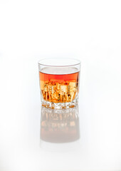 glass of whiskey with ice on white background