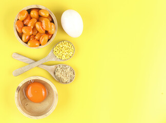 Top view of Thai dessert and ingredient - Mung bean paste formed in egg yolk and sugar on yellow background