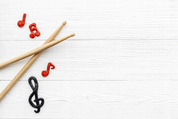 Drum sticks with music notes, overhead view. Music background