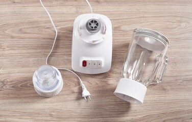 White electric blender on the wooden background.