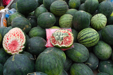 Big heap of watermelons on street market. Carved watermelons. Pakse - Laos 