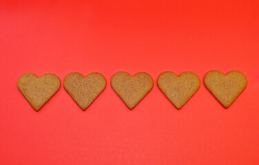 Heart shaped cookies on a red background with copy space for text. February 14, Valentine's Day or Mother's Day