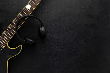 Desk of musician for songwriter work set with headphones and guitar