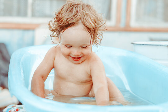 a little boy is bathing in a bath