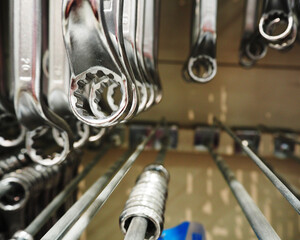 a lot of metal wrenches are hanging in the construction supermarket