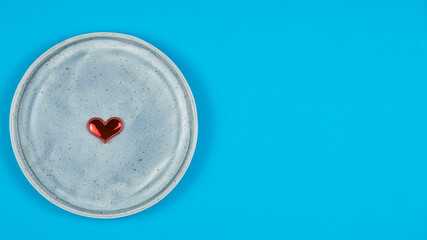 Round plate with red heart. Space for text
