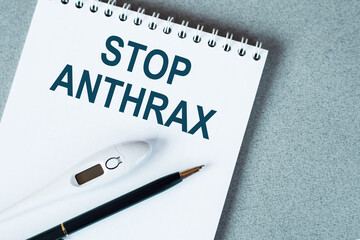 On a purple background a stethoscope with yellow list with text STOP ANTHRAX