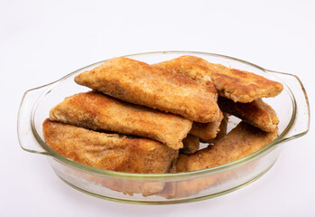 Breaded fish fillets in a glass, heat-resistant dish
