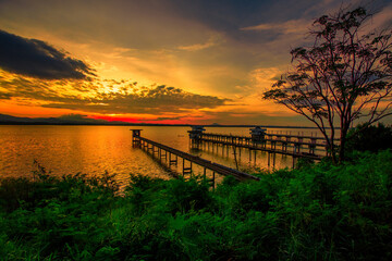The background of the bridge stretches into the sea, with twilight light in the morning, beautiful colors, sky wallpaper and refreshing surroundings.