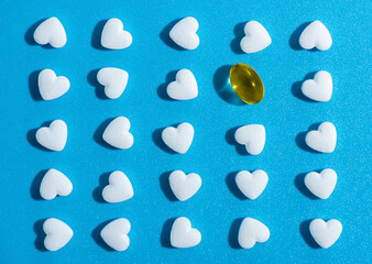 heart-shaped tablets and yellow gelatin pill. pattern medicine