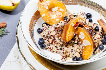 
quinoa porridge with caramelized pear and berries. morning breakfast
