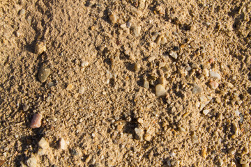 Extreme macro close up of fine beach sand surface pattern in the summer. Sandy trails, texture and background. Top view. Abstract Background. 