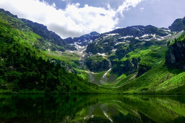 Fototapeta na wymiar wonderful landscape with a mountain lake and snow on the mountains