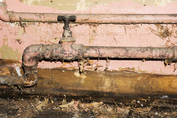 Dirty water pipe. Old pipeline construction. Rusty plumbing system. House renovation background.