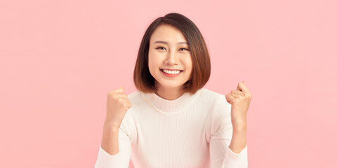 Beautiful young woman over isolated background excited for success with arms raised celebrating...