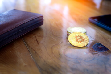 Golden Bitcoin on wooden desk, busines concept.
