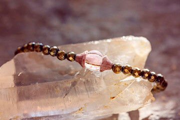 Mineral gemstone bracelet placed on natural grey background