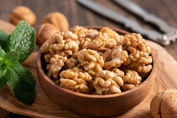 Walnuts in a wooden bowl. Shelled walnuts. Healthy organic nuts