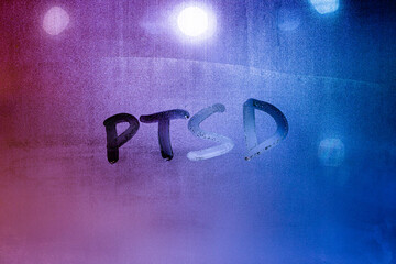 abbreviation ptsd - post traumatic stress disorder - handwritten on night wet window glass
