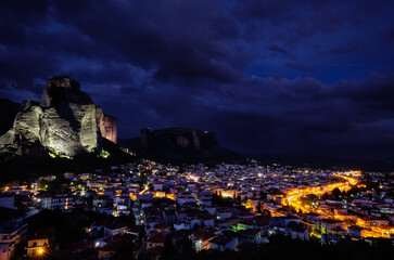 Night view of Kalambaka and Kastraki village at foot of high cliffs and rocks of Meteora valley. Greece, UNESCO World Heritage