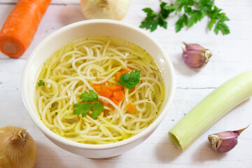 Tasty chicken broth with noodles and vegetables