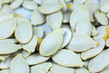 Fresh Pumpkin seeds background. Close up shot.