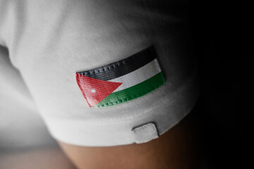 Patch of the national flag of the Jordan on a white t-shirt