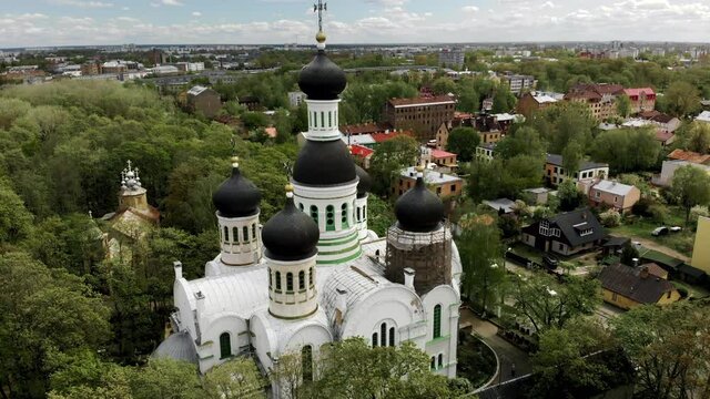 Aerial orbit shot of old orthodox church of St. John the Forerunner in Riga with dome on reconstruction