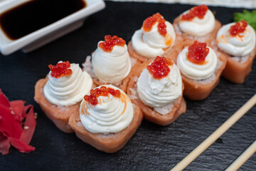 Delicious, juicy and appetizing Philadelphia rolls deluxe with red caviar