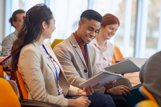 Business people reading documents at a meeting in a conference hall. People, job, company, business concept.