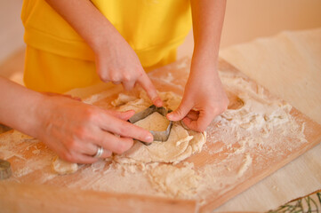 young girl is cooking cake with mother