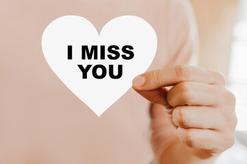 Man holding a love card in the shape of a heart with I miss you