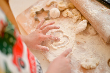 Young girl is cooking christmas cakes