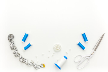 Sewing accessories and sewing supplies. Spools of thread, scissors and centimeter