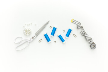 Sewing accessories and sewing supplies. Spools of thread, scissors and centimeter