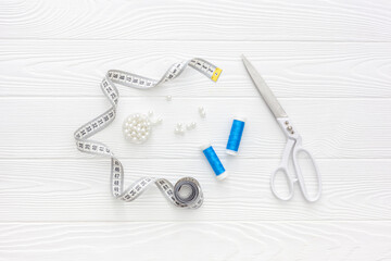 Sewing accessories and sewing supplies. Spools of thread, scissors and centimeter