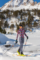 Woman in the mountains practicing mountain skiing in the Pyrenees of Andorra in 2021.