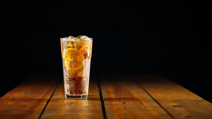 Fresh fizz long island ice tea cocktail in a glass on the wooden table