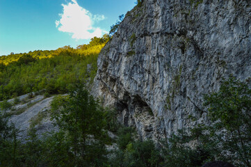 Rocky formation and lush green vegetation, sunshine over natural landscape in, Sohodol Gorges(Cheile Sohodolului), Valcan mountains, in Gorj county, Romania