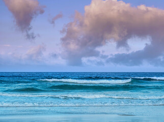 Waves lap at dawn on the beach in Tarifa, Spain