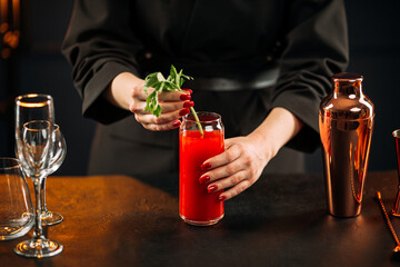 Closeup on making bloody mary cocktail with celery stalk