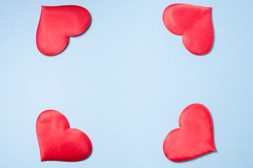 Four hearts on a blue background. The hearts form a kind of frame.