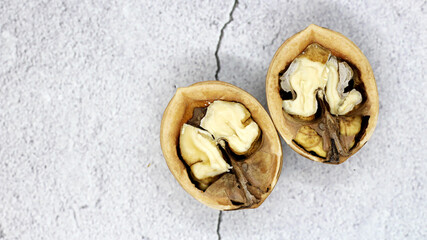 walnut and a cracked walnut so close, top view