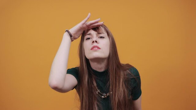 Portrait holding hand over eyes, looking at long distance confident determined expression, being ambitious far future. Studio shot isolated on background. Young curious keep palm near forehead gazing