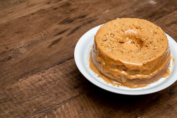 Nut cake on wooden table, view from above. Normal vision.