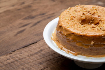 Dulce de leche falling on the cake in the nuts.