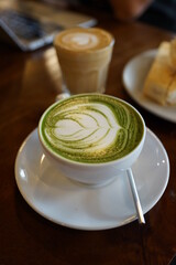 Toasted bread with kaya jam spread served with a cup of green tea latte and flat white latte, Malaysian cafe breakfast set.