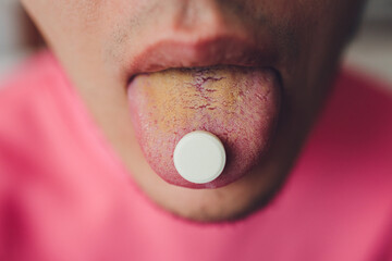beautiful man with lsd on tongue in nightclub with pink smoke.